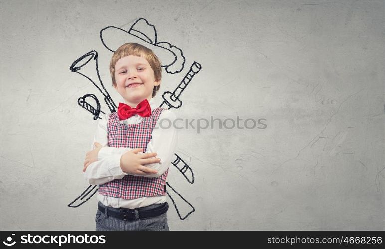Portrait of young boy with drawn hat and guns behind his back