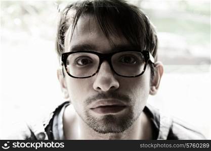 Portrait of young brunette man with glasses