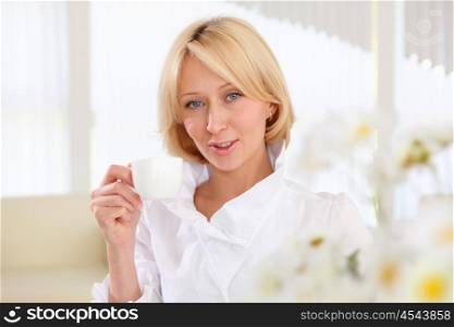 portrait of young business lady holding a tea cup