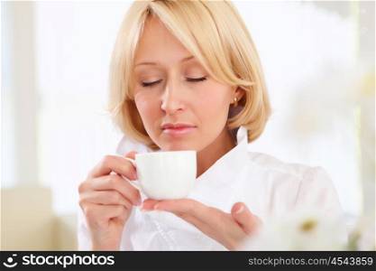 portrait of young business lady holding a tea cup