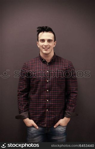 portrait of young business man in casual clothes grey wall in background