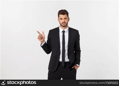 Portrait of young business man in suit pointing at copy space over white background. Portrait of young business man in suit pointing at copy space over white background.