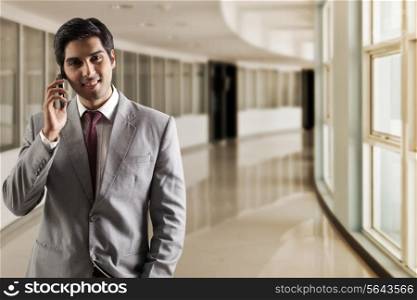 Portrait of young business man talking on phone