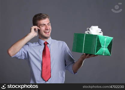 Portrait of young business man with gifts