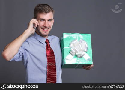 Portrait of young business man with gifts