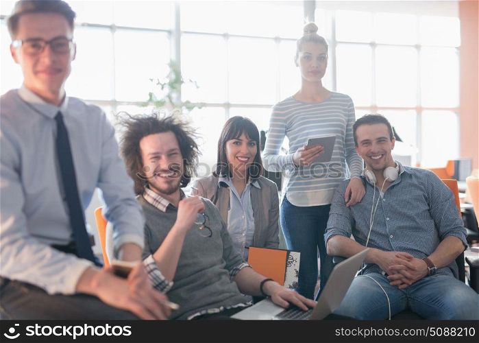 Portrait of young business people discussing business plan in the office