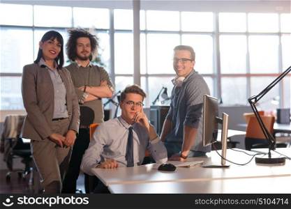 Portrait of young business people discussing business plan in the office