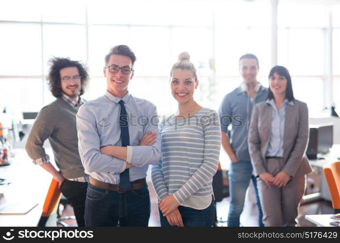 Portrait of young business people discussing business plan in the office