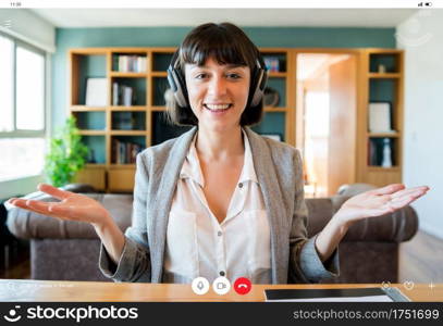 Portrait of young business woman on a video call from home. Home office concept. New normal lifestyle.