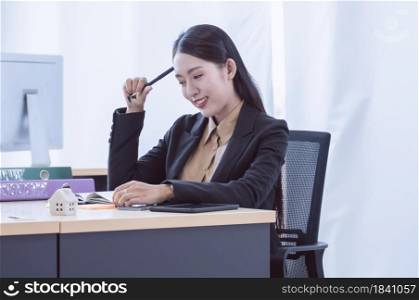 Portrait of young business woman planning her project and working in the office