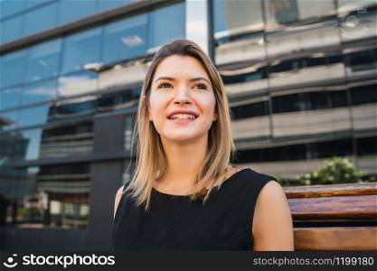 Portrait of young business woman standing outdoors at the street. Business concept.