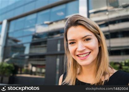 Portrait of young business woman standing outdoors at the street. Business concept.