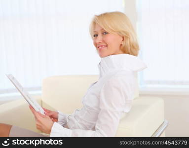 portrait of young business woman with blond hair in the office