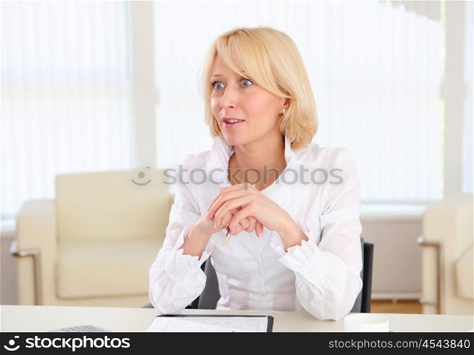 portrait of young business woman with blond hair in the office