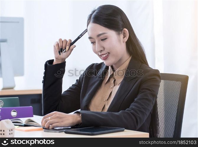 Portrait of young business woman working in the office