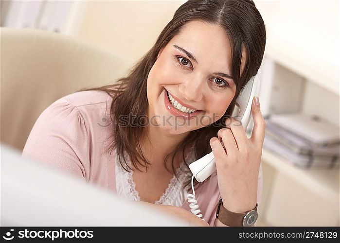 Portrait of young business woman working on the phone