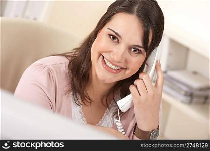 Portrait of young business woman working on the phone