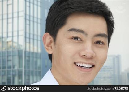 Portrait of young businessman close-up, outdoors, Beijing