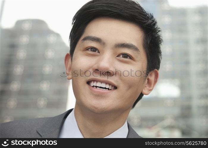 Portrait of young businessman close-up, outdoors, Beijing