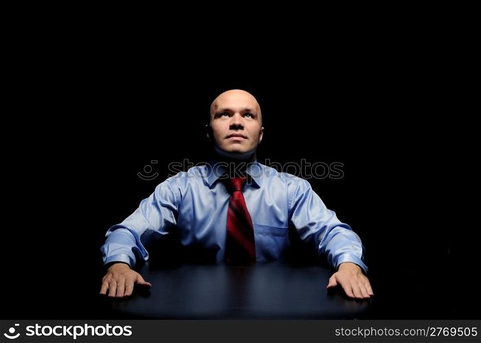 Portrait of young businessman in a dark room