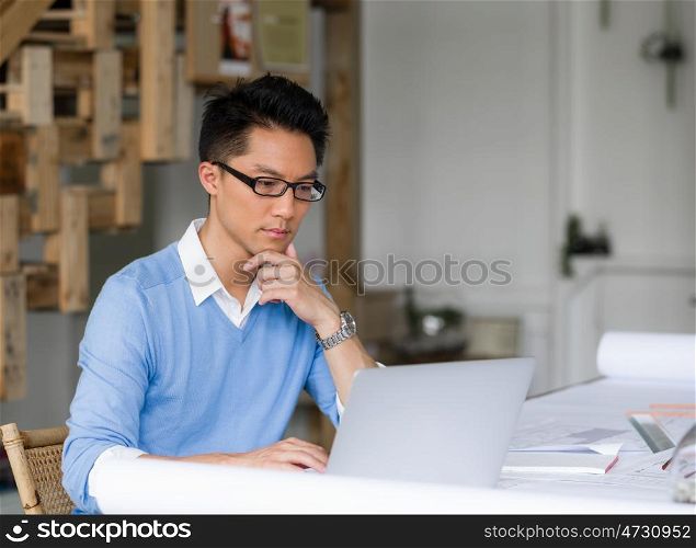 Portrait of young businessman in office with notebook. Portrait of young businessman