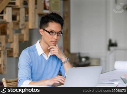 Portrait of young businessman in office with notebook. Portrait of young businessman