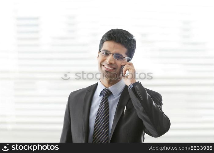 Portrait of young businessman on call