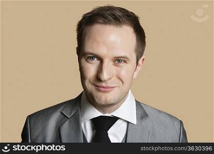 Portrait of young businessman over colored background