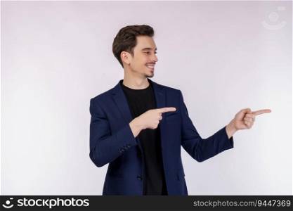 Portrait of young businessman pointing fingers at copy space isolated on white studio background. Smiling guy advertising product or service.