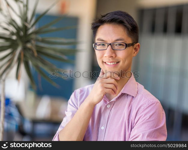 Portrait of young businessman. Portrait of young businessman standing in office