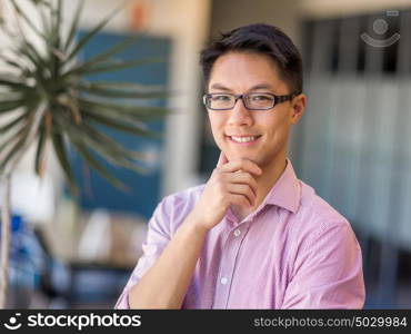 Portrait of young businessman. Portrait of young businessman standing in office