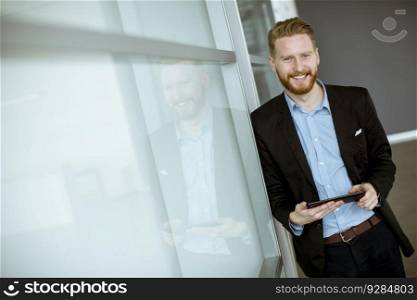 Portrait of young businessman with a tablet pc at the office