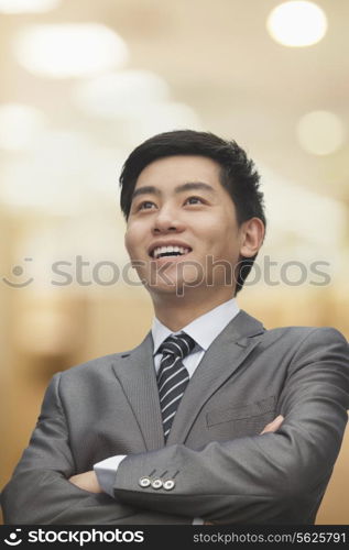 Portrait of young businessman with arms crossed