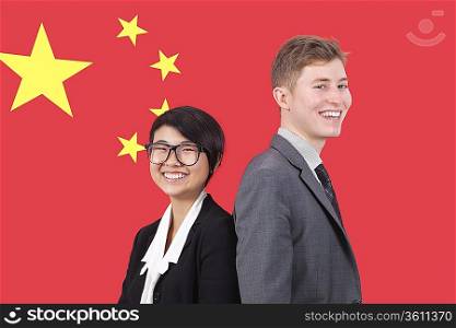 Portrait of young businesswoman and man smiling over Chinese flag