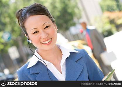 Portrait of young businesswoman at street