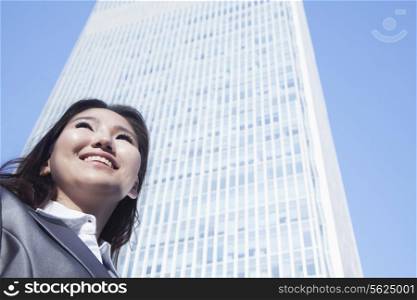 Portrait of young businesswoman by Chinas world trade center building in Beijing