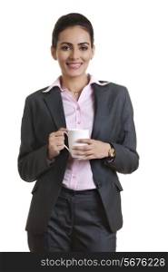 Portrait of young businesswoman holding coffee cup over white background
