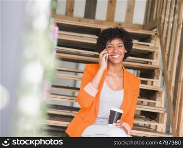 Portrait of young businesswoman in office holding her mobile. Portrait of young businesswoman with mobile