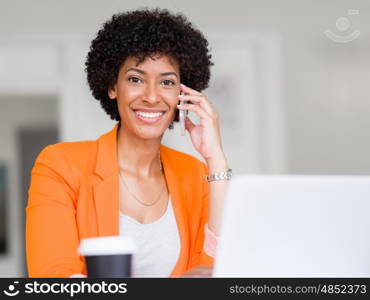 Portrait of young businesswoman in office holding her mobile. Portrait of young businesswoman with mobile