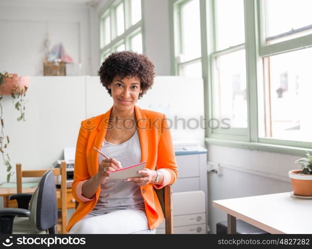 Portrait of young businesswoman in office. Portrait of young businesswoman