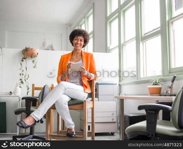 Portrait of young businesswoman in office. Portrait of young businesswoman