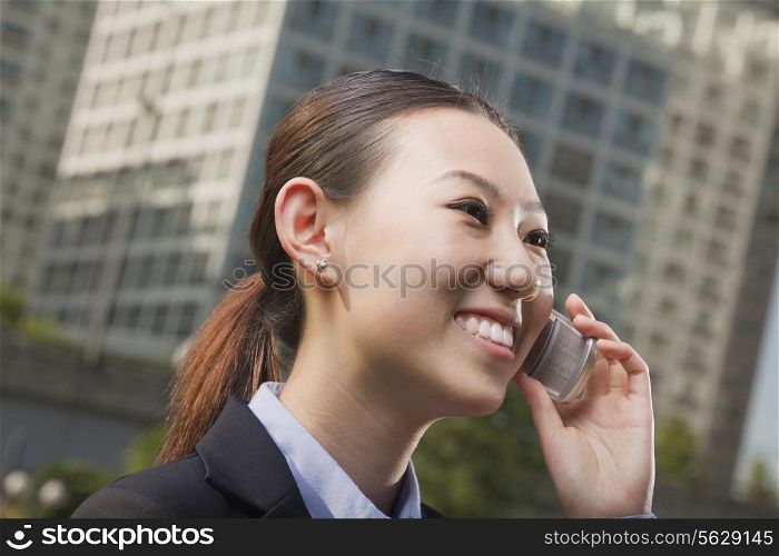 Portrait of young businesswoman on the phone