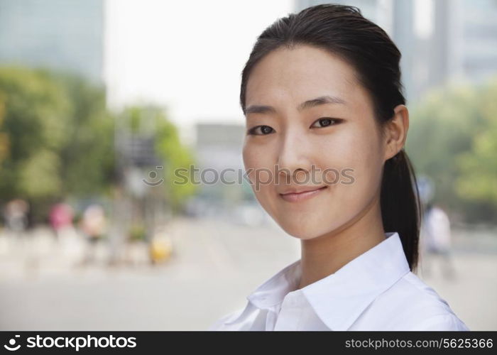 Portrait of young businesswoman smiling outside in Beijing