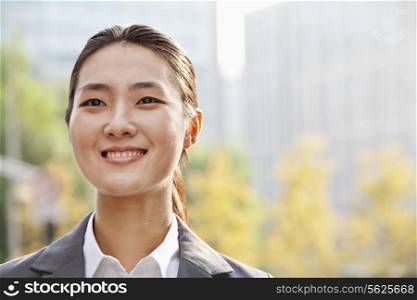 Portrait of young businesswoman smiling outside in Beijing