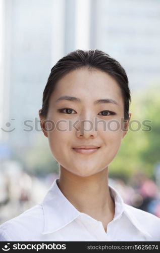 Portrait of young businesswoman smiling outside in Beijing