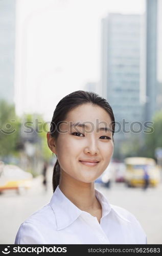 Portrait of young businesswoman smiling outside in Beijing