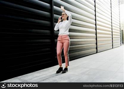 Portrait of young businesswoman using mobile phone on a break at outdoor