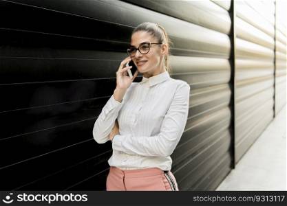 Portrait of young businesswoman using mobile phone on a break at outdoor