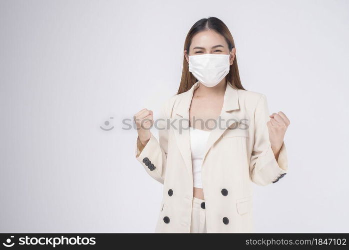 portrait of young businesswoman wearing a surgical mask over white background studio