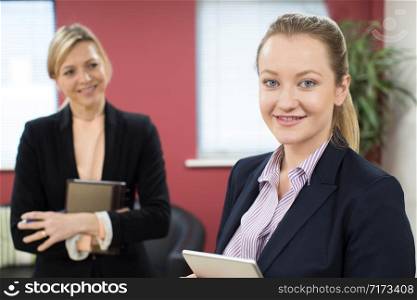 Portrait Of Young Businesswoman With Female Mentor In Office